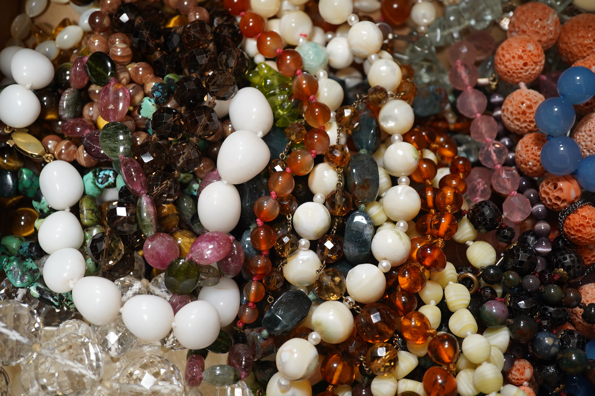 A quantity of assorted bead necklaces including, coral, various agates, turquoise cat's eye quartz, rock crystal, tiger's eye quartz, amethyst, aquamarine etc. Condition - poor to fair to good